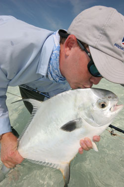 Captain Steve Freidman of Islamorada kisses his latest permit catch off Sugarloaf Key